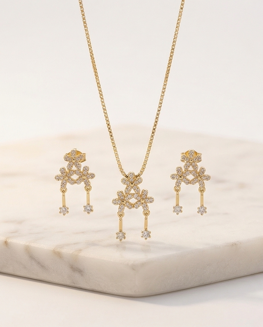 Gold-toned chain with floral crystal pendant.